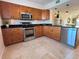 Well-lit kitchen features stainless steel appliances, granite countertops, and wood cabinets at 1720 Lighthouse S Ter # 8, South Pasadena, FL 33707