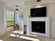 Cozy living room featuring a fireplace, large window, and comfortable seating at 1720 Lighthouse S Ter # 8, South Pasadena, FL 33707