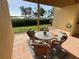 Covered patio with seating overlooking landscaped yard at 1720 Lighthouse S Ter # 8, South Pasadena, FL 33707