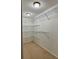 Walk-in closet featuring wire shelving, neutral carpet and overhead lighting at 1720 Lighthouse S Ter # 8, South Pasadena, FL 33707