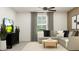 Modern living room with a sectional sofa, a round coffee table, and a sleek entertainment center with a TV at 1814 Tropical Oasis Ave, Plant City, FL 33565