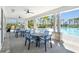 Covered outdoor seating area overlooking the community pool with comfortable seating and ceiling fans at 1814 Tropical Oasis Ave, Plant City, FL 33565