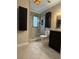This bathroom has tiled floors, a glass enclosed shower and floating dark colored cabinets at 2140 Redleaf Dr, Brandon, FL 33510