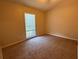 A simple bedroom with neutral walls, carpeted floors, and a window with blinds at 2140 Redleaf Dr, Brandon, FL 33510