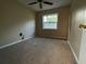 An empty bedroom with carpet flooring, neutral walls, and a window at 2140 Redleaf Dr, Brandon, FL 33510