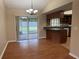 Dining room features laminate flooring, a chandelier, and sliding glass doors to the backyard at 2140 Redleaf Dr, Brandon, FL 33510