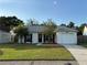 Charming single-story home with a well-manicured lawn and an attached garage at 2140 Redleaf Dr, Brandon, FL 33510