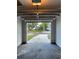 An attached garage with an open door looking out onto the driveway and the street at 2140 Redleaf Dr, Brandon, FL 33510