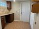 Laundry room with cabinets, a countertop, tile flooring, and a door to the exterior at 2140 Redleaf Dr, Brandon, FL 33510