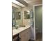 Bright bathroom featuring a sink with vanity, framed mirrors, and decorative towel bars at 2583 Countryside Blvd # 3102, Clearwater, FL 33761