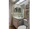 Well-lit bathroom with vanity, sink, mirror, toilet and decorative shower curtain at 2583 Countryside Blvd # 3102, Clearwater, FL 33761