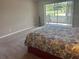 Bedroom with sliding glass doors leading to a private patio with a view of lush greenery at 2583 Countryside Blvd # 3102, Clearwater, FL 33761