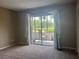 Bright bedroom with sliding glass doors leading to a private patio and outdoor seating at 2583 Countryside Blvd # 3102, Clearwater, FL 33761