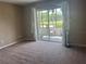 Bright bedroom with sliding glass doors leading to a private patio and outdoor seating at 2583 Countryside Blvd # 3102, Clearwater, FL 33761