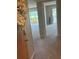 Entryway hallway featuring carpet, views to the exterior, and a decorative wreath at 2583 Countryside Blvd # 3102, Clearwater, FL 33761