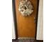 Entry doorway with a decorative wreath, electronic door lock, and a patterned welcome mat at 2583 Countryside Blvd # 3102, Clearwater, FL 33761