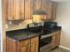 Well-equipped kitchen featuring sleek countertops, wood cabinetry, and modern appliances at 2583 Countryside Blvd # 3102, Clearwater, FL 33761