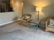 Cozy living area featuring wicker chairs, accent table, and a warm, inviting ambiance at 2583 Countryside Blvd # 3102, Clearwater, FL 33761
