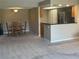 Open-concept living area with dining table and chairs, flowing into the kitchen with bar seating at 2583 Countryside Blvd # 3102, Clearwater, FL 33761