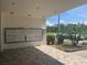 Condo mailboxes underneath a covered area on a tiled floor with a view of the parking lot and landscaping at 2583 Countryside Blvd # 3102, Clearwater, FL 33761