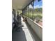 Screened-in patio provides an outdoor retreat with seating and views of green landscape at 2583 Countryside Blvd # 3102, Clearwater, FL 33761