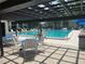 Community pool with lounge chairs and a shaded seating area; perfect for relaxation at 2583 Countryside Blvd # 3102, Clearwater, FL 33761
