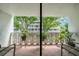 Balcony has potted plants, chairs, and offers a view of the building and surrounding greenery at 2612 Pearce Dr # 209, Clearwater, FL 33764