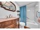 Bathroom featuring a granite countertop sink, mirror and shower with blue curtain at 2612 Pearce Dr # 209, Clearwater, FL 33764