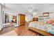 Cozy bedroom with hardwood floors, ceiling fan, and decoratively themed furniture and artwork at 2612 Pearce Dr # 209, Clearwater, FL 33764