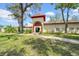Beautiful community building surrounded by trees and grass at 2612 Pearce Dr # 209, Clearwater, FL 33764