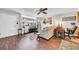 Open living room with hardwood floors, ceiling fan and a view of the balcony at 2612 Pearce Dr # 209, Clearwater, FL 33764