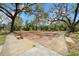 Community tennis court surrounded by large, mature trees for ample shade at 2612 Pearce Dr # 209, Clearwater, FL 33764