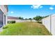 Large backyard surrounded by a white fence and lush green grass at 312 Taxter Run Ln, Valrico, FL 33594