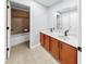 Bathroom with double sink vanity, a large mirror, light tile flooring, and tub with shower at 312 Taxter Run Ln, Valrico, FL 33594