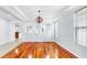 Open dining room with hardwood floors, chandelier, and natural light from large windows at 312 Taxter Run Ln, Valrico, FL 33594