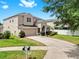 Charming two-story home featuring a well-maintained lawn, arched entryway, and an attached two-car garage at 312 Taxter Run Ln, Valrico, FL 33594