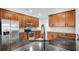 Stylish kitchen featuring stainless steel appliances, dark granite countertops, and ample cabinetry at 312 Taxter Run Ln, Valrico, FL 33594