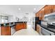 Spacious kitchen boasts stainless steel appliances, granite counters, and wood cabinetry at 312 Taxter Run Ln, Valrico, FL 33594