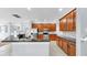 Open kitchen boasts dark countertops, wood cabinetry, stainless appliances and tile floor at 312 Taxter Run Ln, Valrico, FL 33594