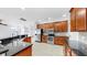 Spacious kitchen features dark countertops, wood cabinetry, stainless appliances, and tile floor at 312 Taxter Run Ln, Valrico, FL 33594