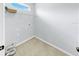 Tiled laundry room with upper window, wire shelving, and washer/dryer hookups at 312 Taxter Run Ln, Valrico, FL 33594