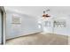 Inviting living room with a ceiling fan, neutral carpet, and transom windows at 312 Taxter Run Ln, Valrico, FL 33594