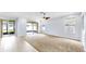 Cozy living room features neutral carpeting, a ceiling fan, and sliding door access to the patio at 312 Taxter Run Ln, Valrico, FL 33594