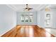 Welcoming living room with hardwood floors, arched windows, and a glass-paneled front door at 312 Taxter Run Ln, Valrico, FL 33594