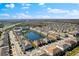 An attractive aerial view showcases this well-planned community, featuring a lake, homes, and landscaping at 3214 Painted Blossom Ct, Lutz, FL 33558
