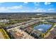 This aerial showcases a lovely community with a large pond, mature trees, and attractive residences at 3214 Painted Blossom Ct, Lutz, FL 33558
