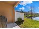 Outdoor patio area with barbecue and privacy fence with a scenic lake view at 3214 Painted Blossom Ct, Lutz, FL 33558