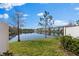 Outdoor patio area with privacy fence, with a scenic lake view at 3214 Painted Blossom Ct, Lutz, FL 33558