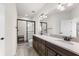 Modern bathroom features dual vanities, a large mirror, and a glass-enclosed shower at 3214 Painted Blossom Ct, Lutz, FL 33558