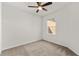 Neutral bedroom features carpet, a ceiling fan, and a window providing ample natural light at 3214 Painted Blossom Ct, Lutz, FL 33558